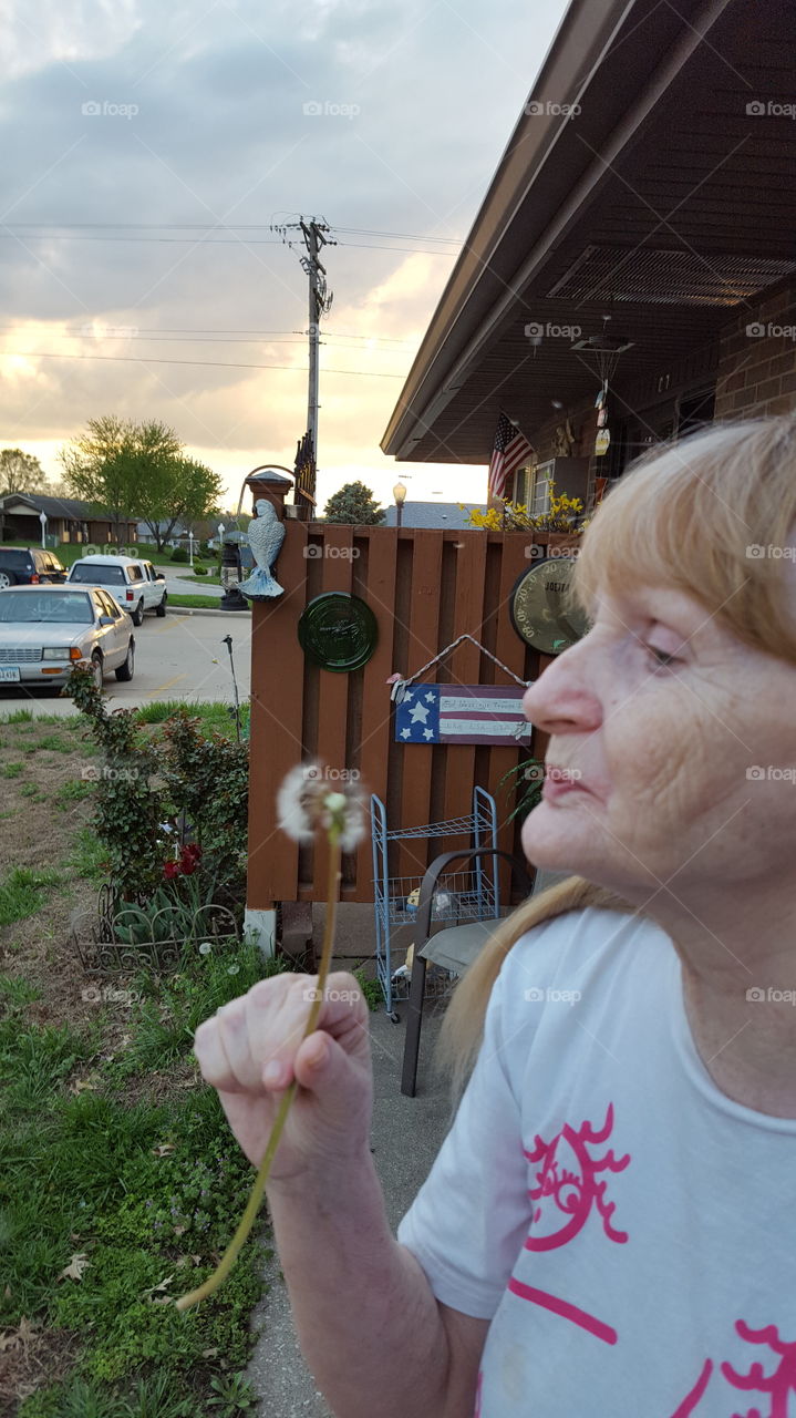 mom blowing a dandelion