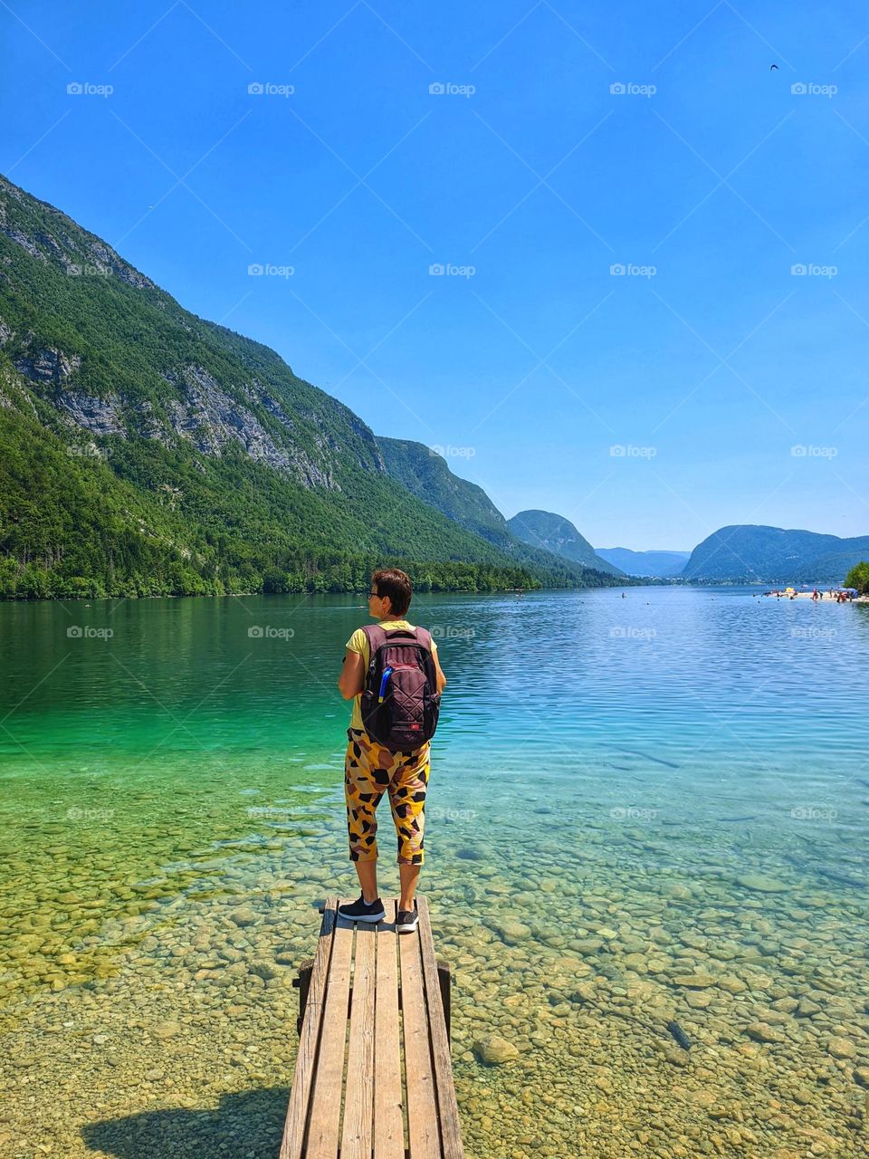 Scenic view of green Alps mountains against blue sky and beautiful lake in Slovenia. Summer time. Vacation. Landscape