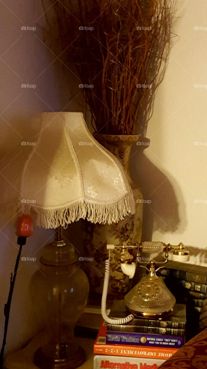 coach end table with lamp vase and antique phone