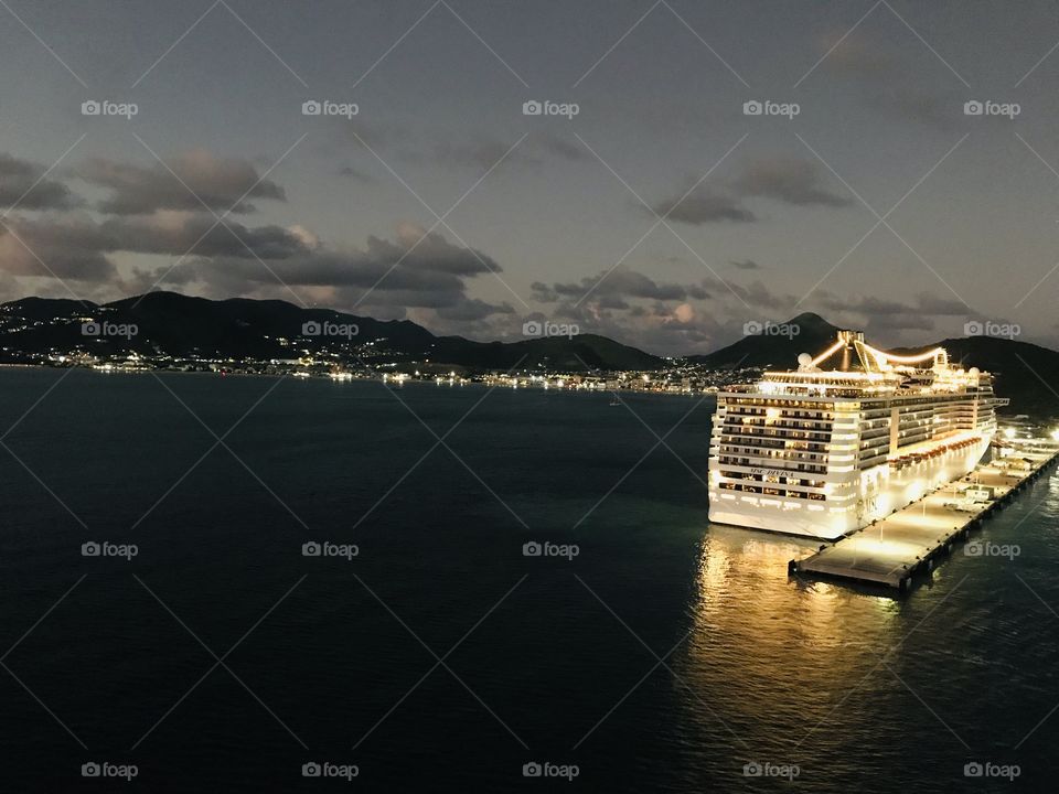 Gorgeous night time photo of ocean with cruise ship that is docked for the night!! 