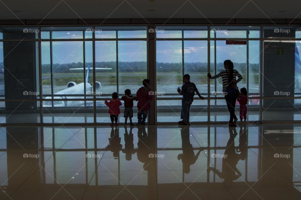 Waiting for arrival at the airport window.