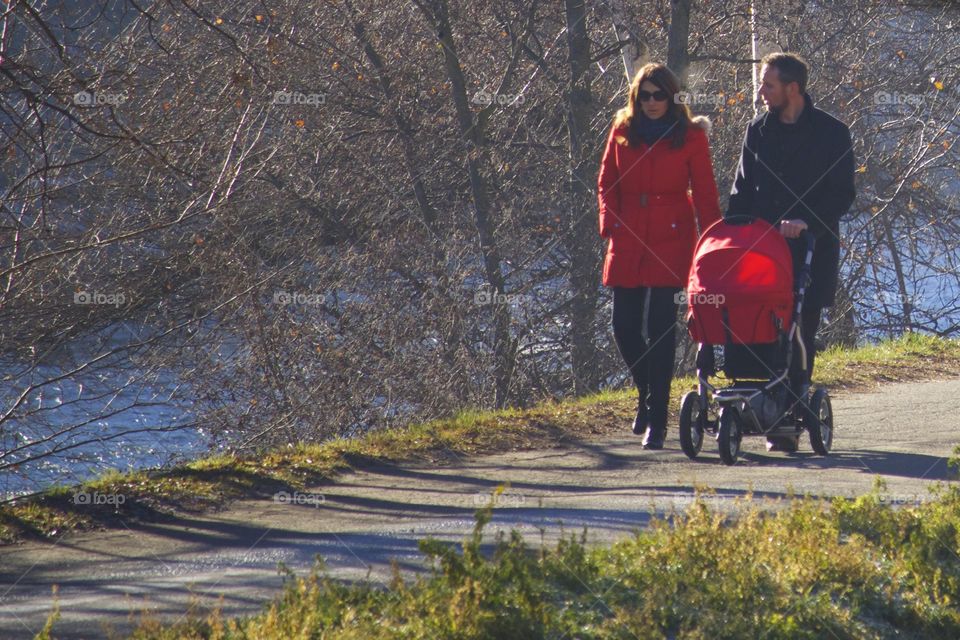 Couple Walking With The Baby Outdoors