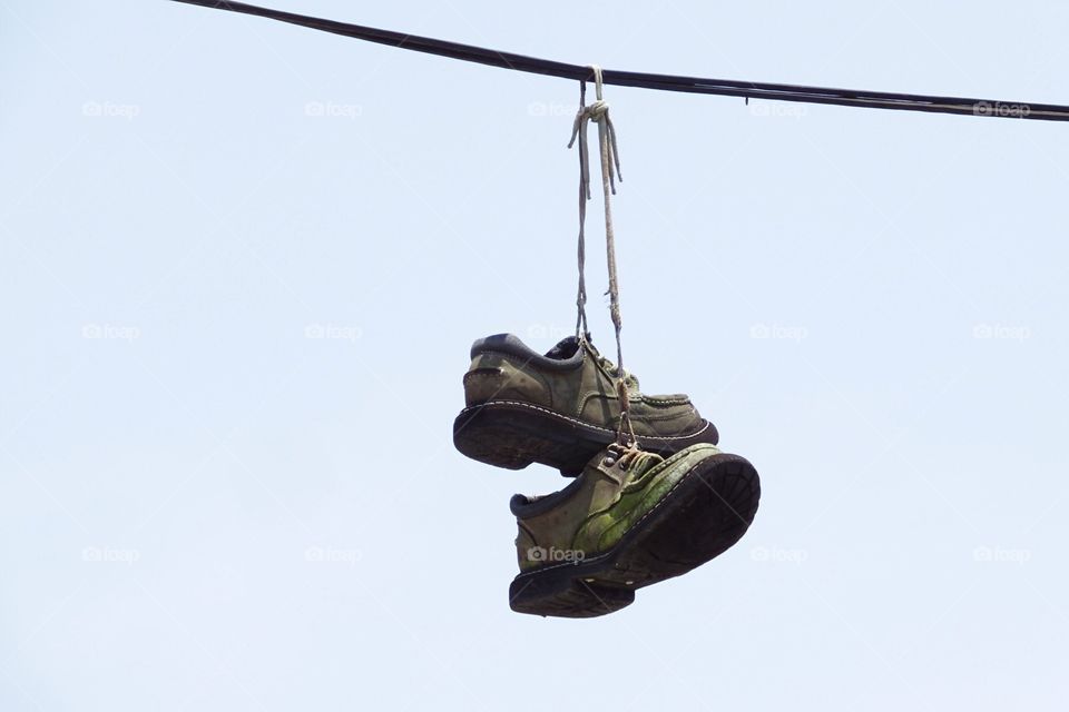 Shoefiti-Workboots over a high wire.