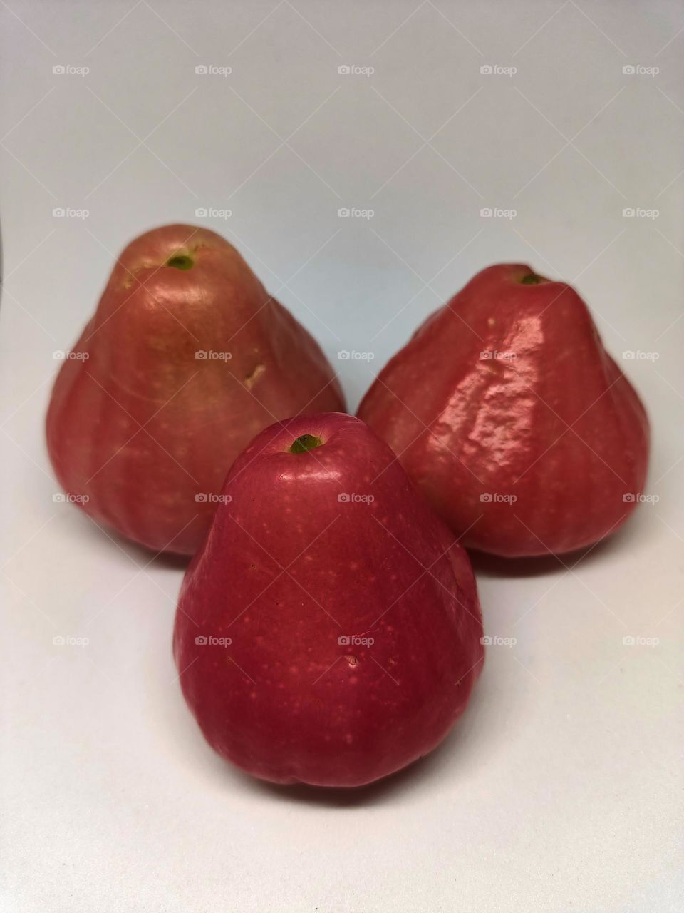 Close up of wax apple isolated on white background. Selective focus, underexposed, blurry, low light, too soft