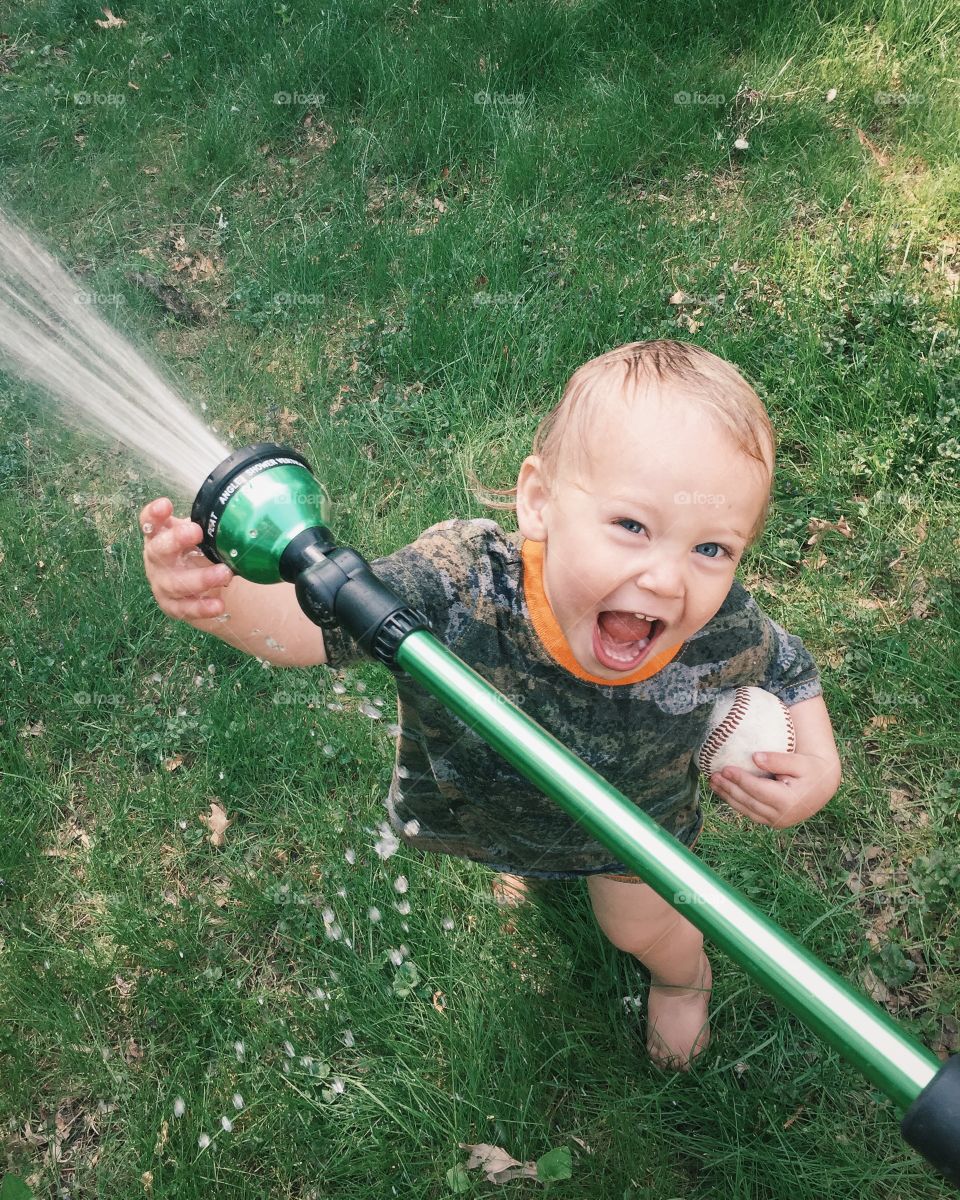 Child playing with hose