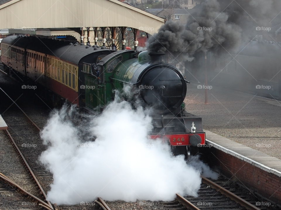 Steam train at Bo’ness in Scotland showing smoke and steam. 