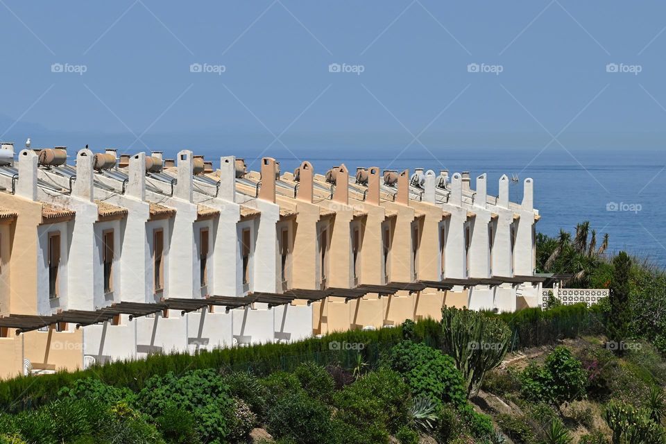 Row of houses with a sea view.