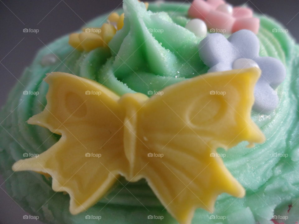 yellow butterfly on cupcake