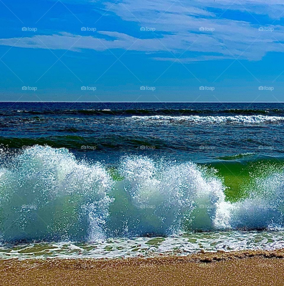 waves crashing against shore on the beach
