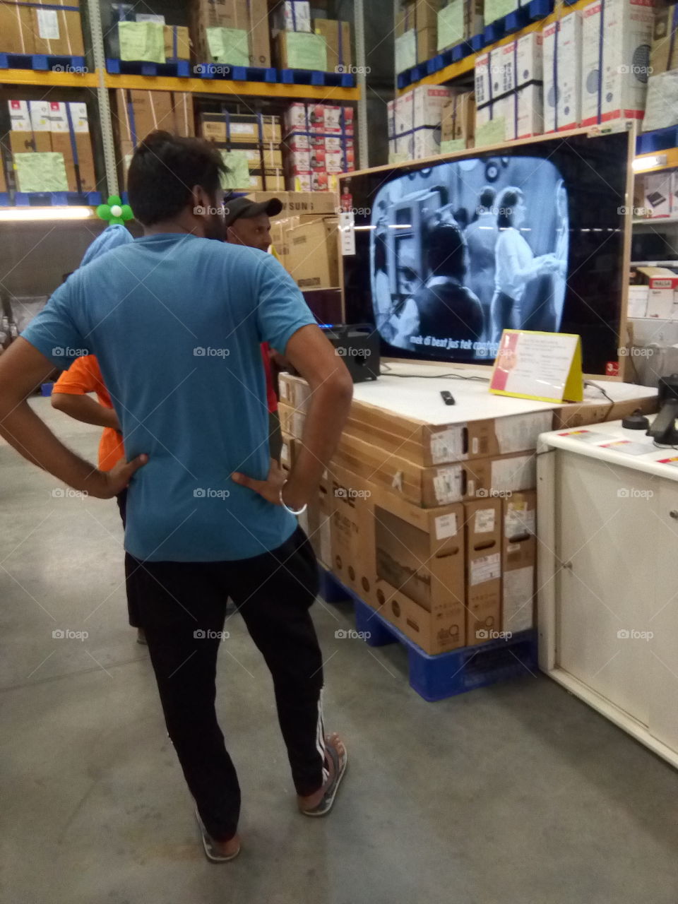 people watching TV in a mall.