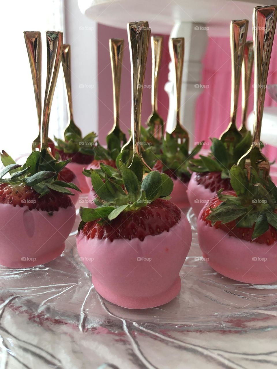 Strawberries in white chocolate with gold fork