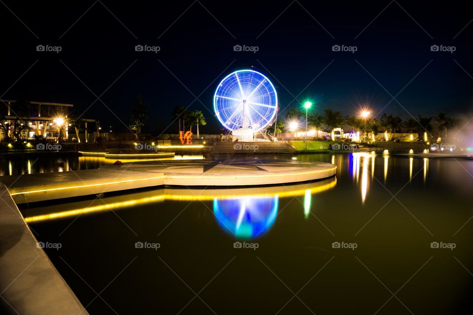 night view of the playground with a big Ferris wheel