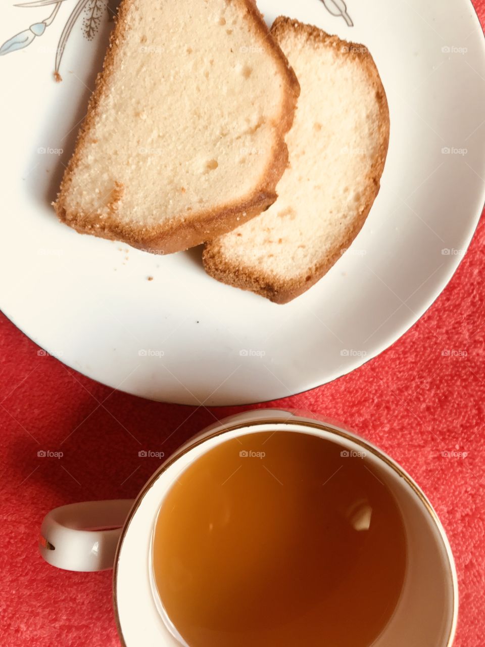 Breakfast delicious slice cake and hot tea red background 