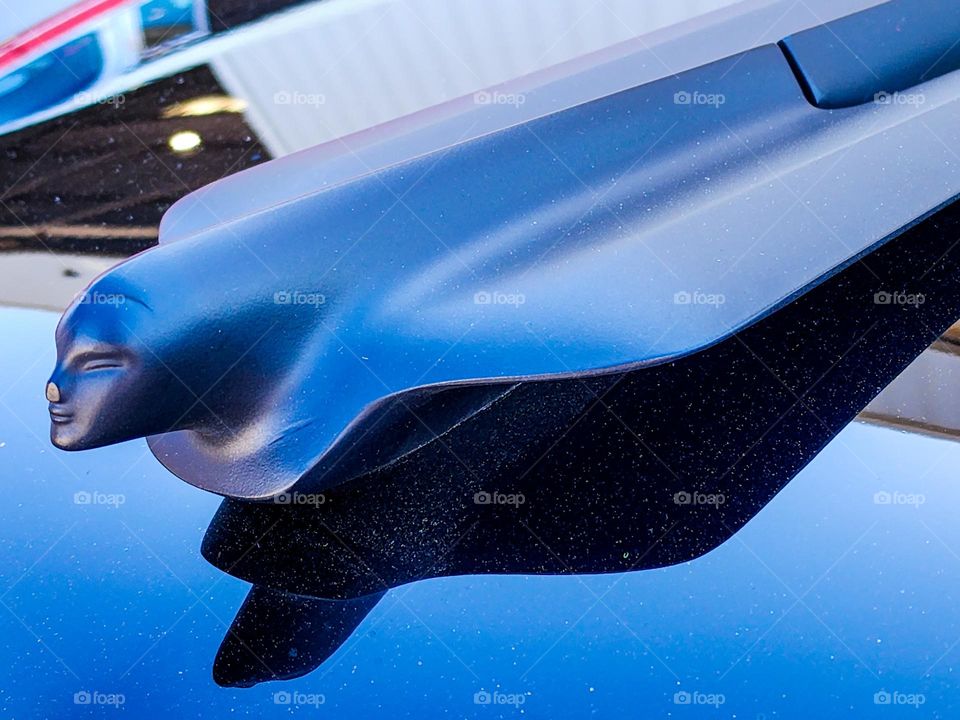 A stylized hood ornament graces a heavily modified classic Cadillac roadster