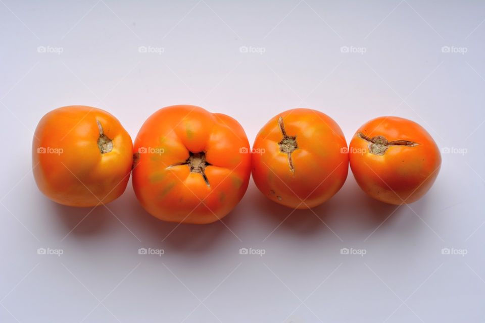 yellow tomatoes harvest on a white background