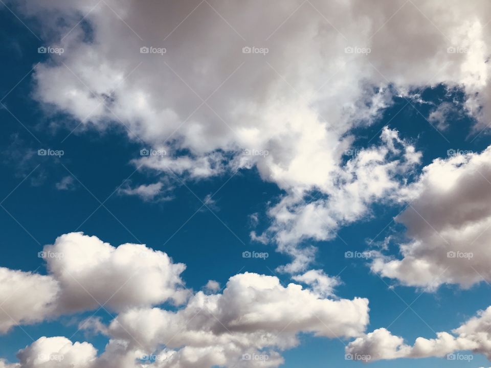 Beautiful blue sky with white puffy clouds 