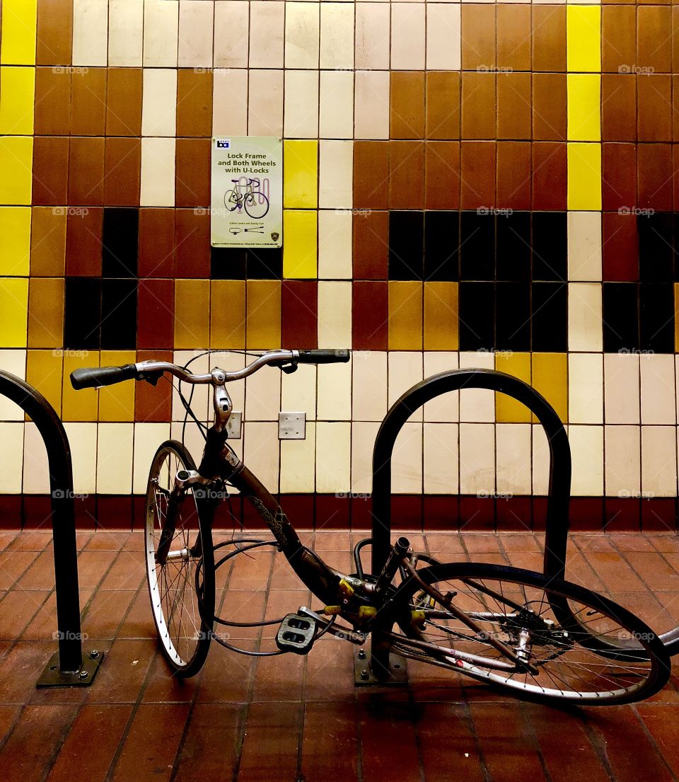 A defective bike abandoned in a public transportation building 