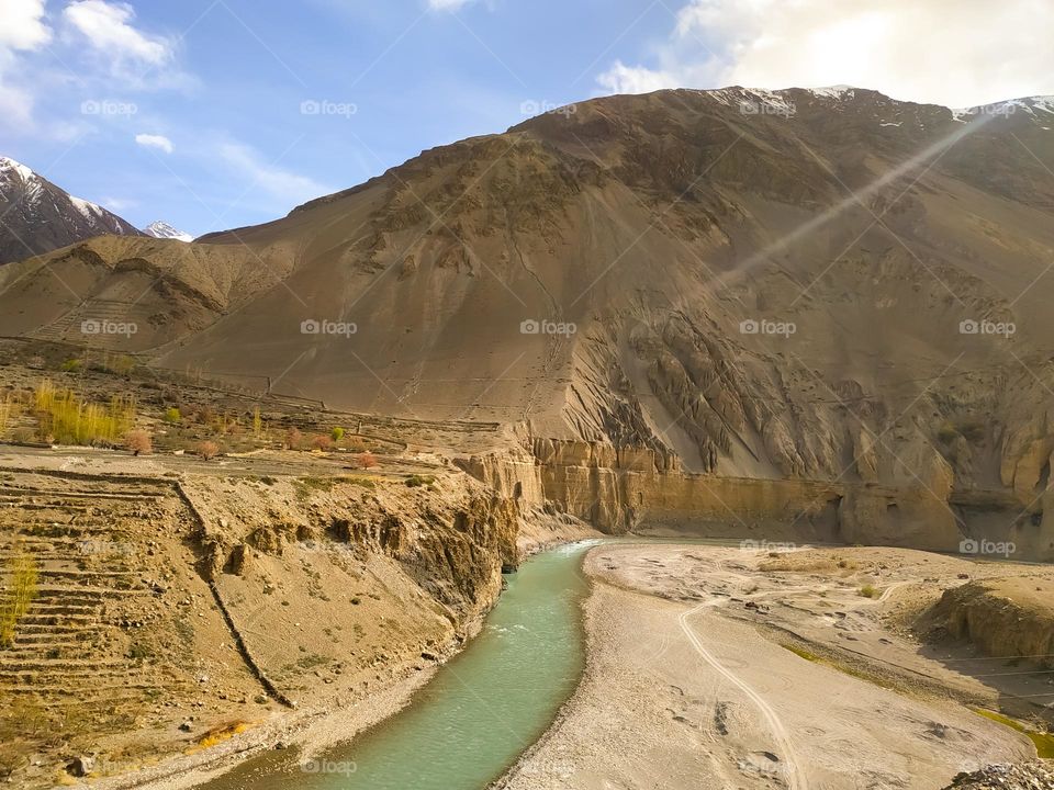mountain river in the Himalayas with clouds and sky