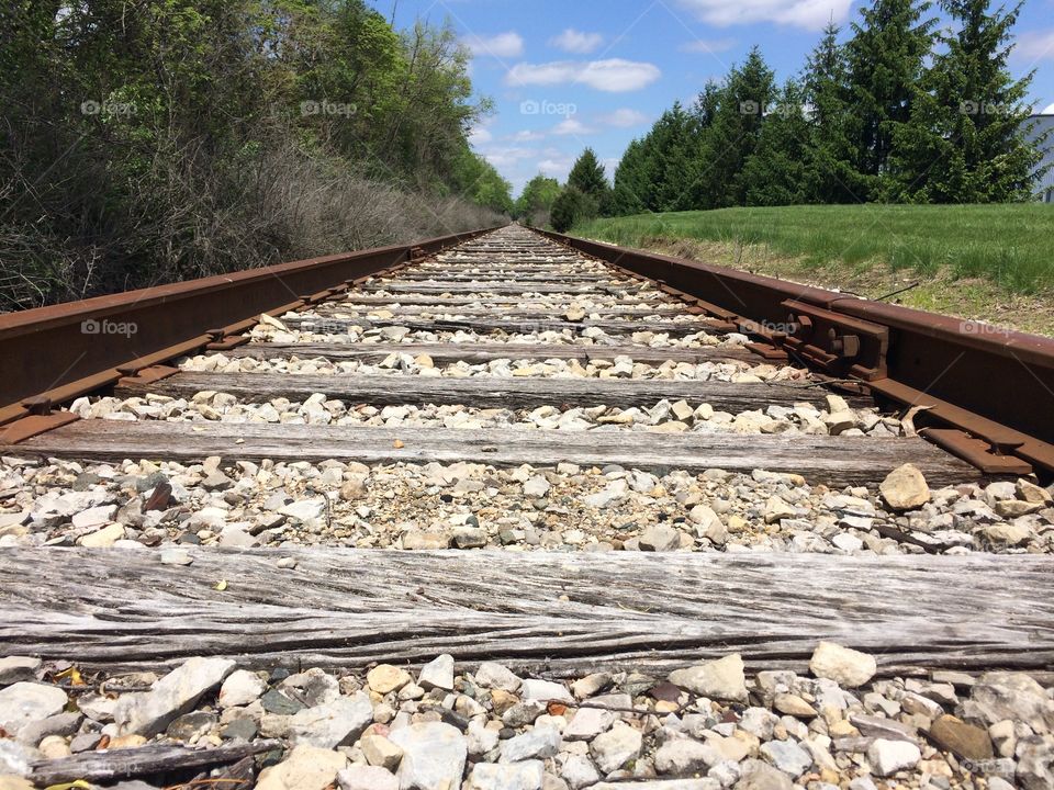 Empty railroad against blue sky