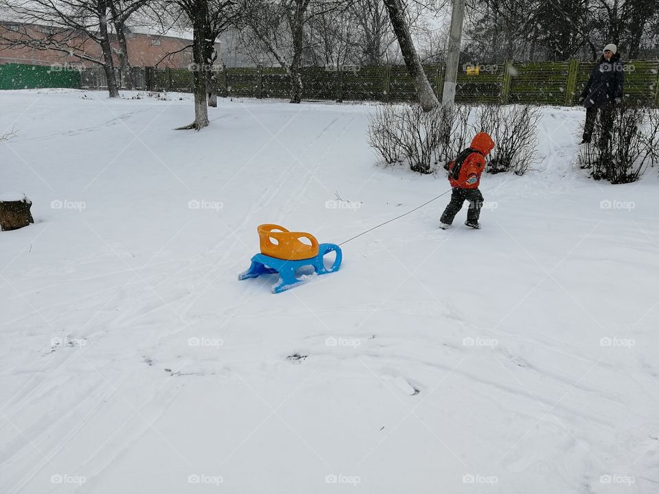 boy drag the toboggan