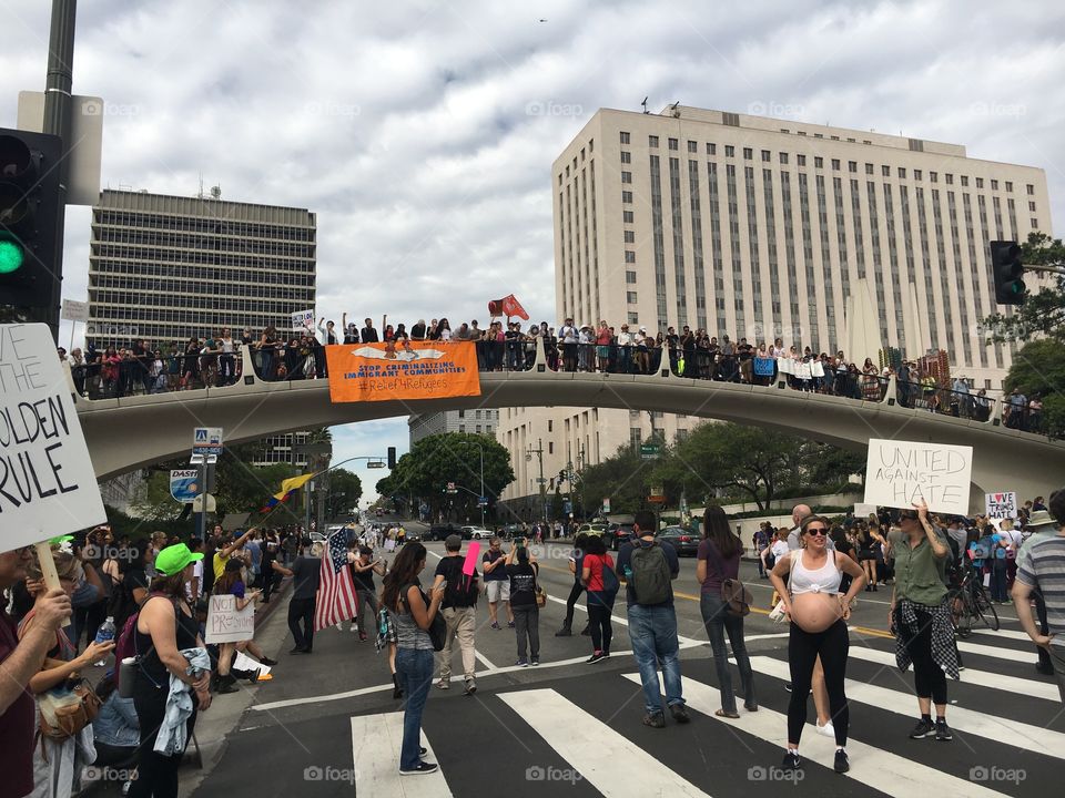 Protesters standing on and under a bridge in LA. 