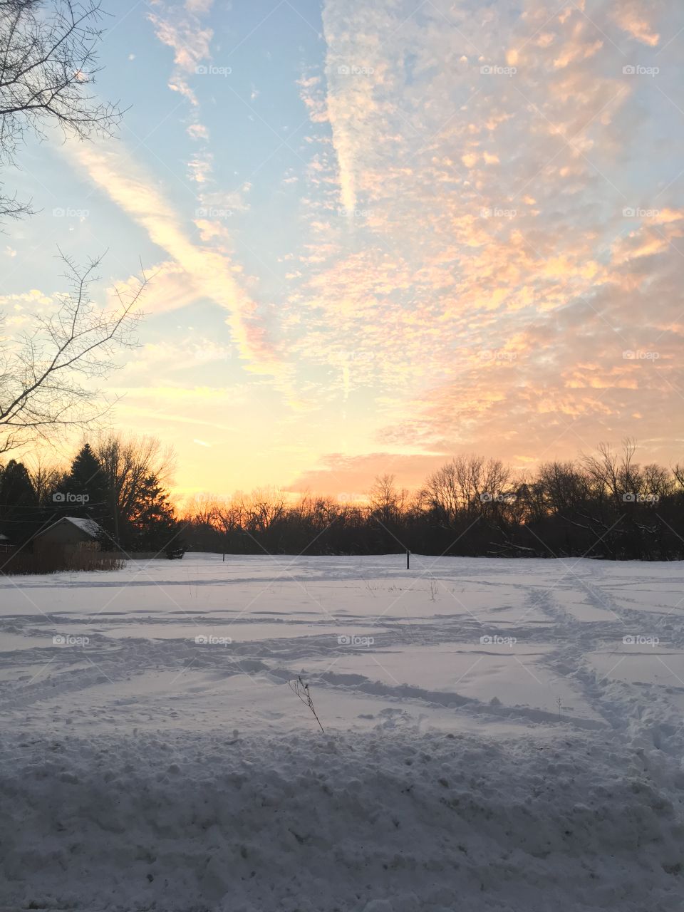 Sunset over snowy field