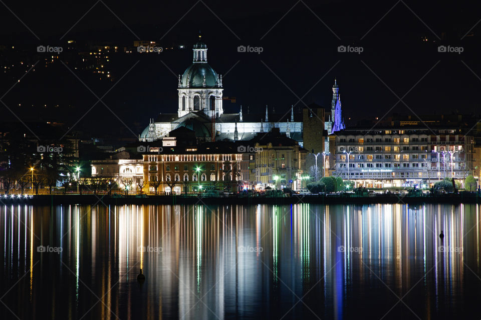 Nightscape in Como with its cathedral and thousand lights that are reflected in the lake.