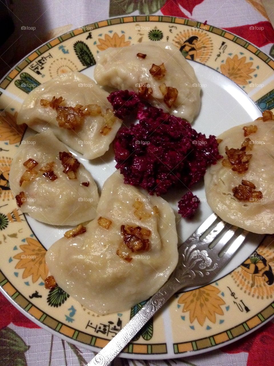 Homemade Ukrainian national dish Varenyky with beetroot salad on a plate