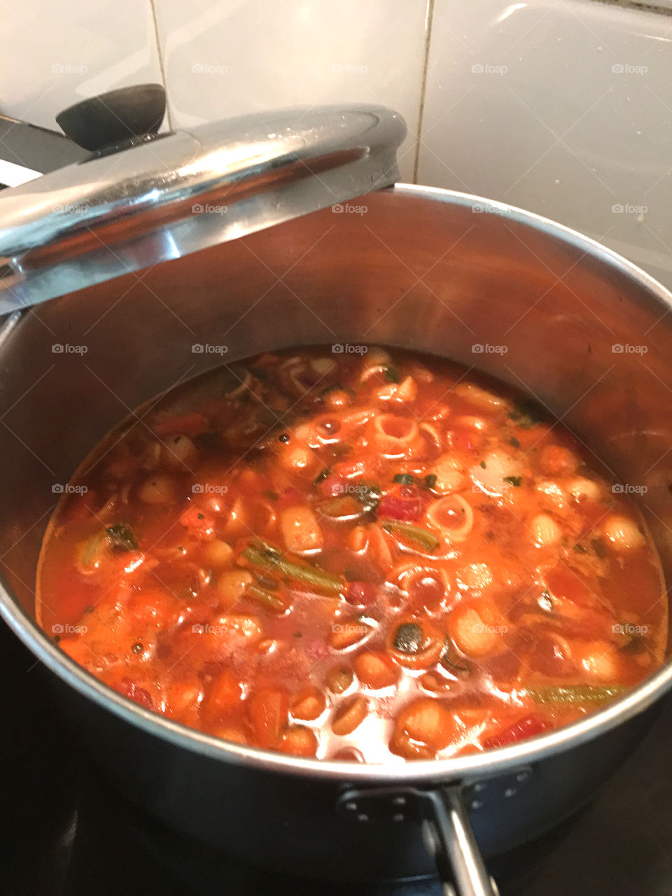 What's cooking? Italian minestrone soup, shown here cooking in a stainless steel pot on the stove with the lid off