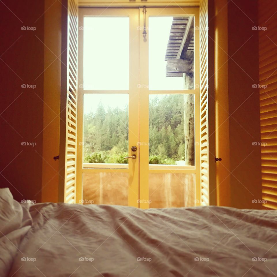 Daylight through open window in hotel room 