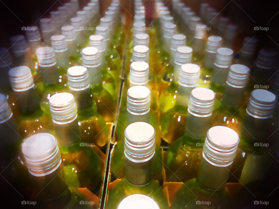 Rows of sparkling wine bottles.