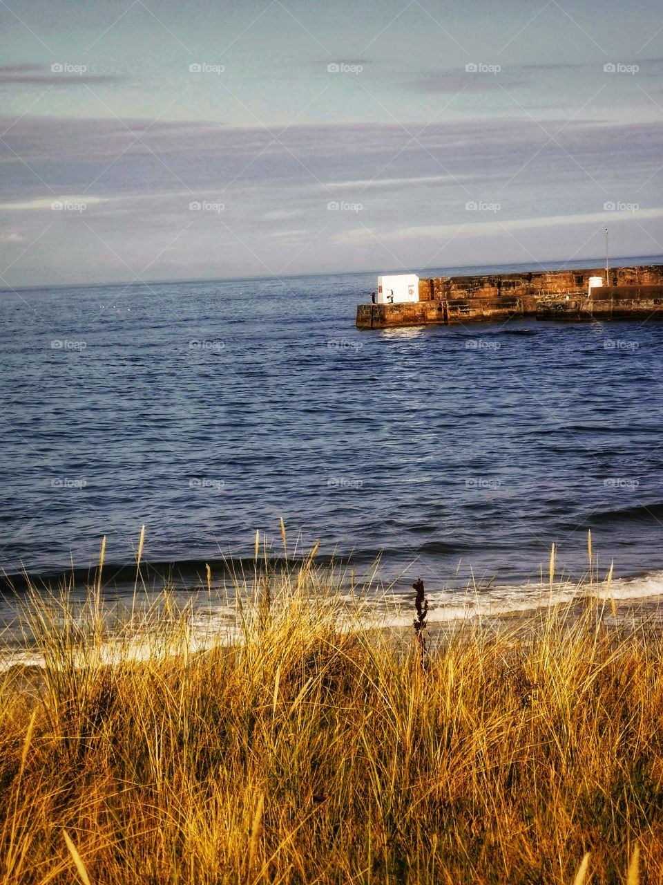 Seaside with men fishing