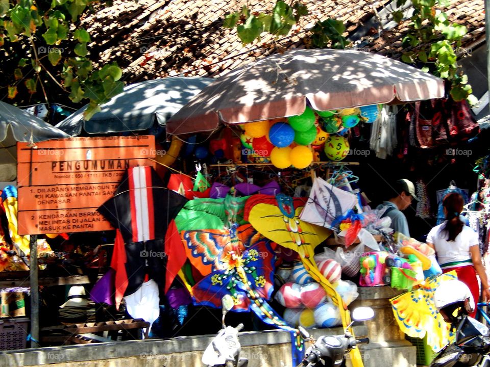 They sell any colorful kites and rainbow balloon.