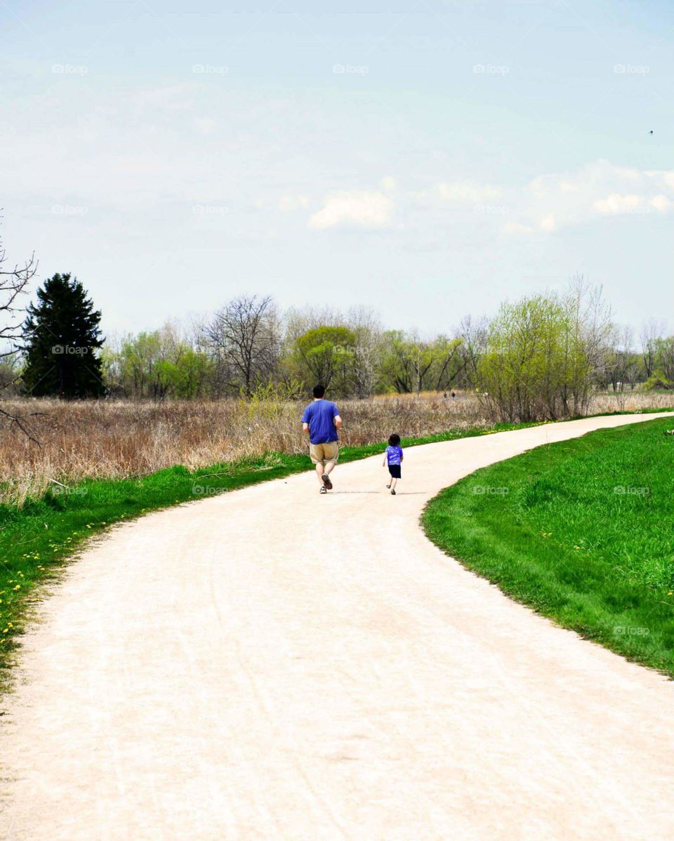 Daddy and me. Father and son walking along trail at Rollins  Savanna Preserve near Chicago, Illinois