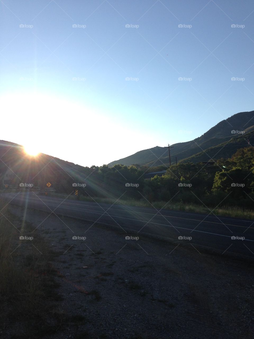 Sunrise behind the mountain. Sun rising behind mountains in Utah. 