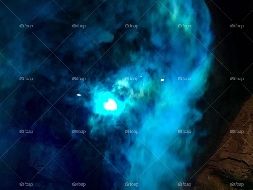 Blue and green light going through a mist.