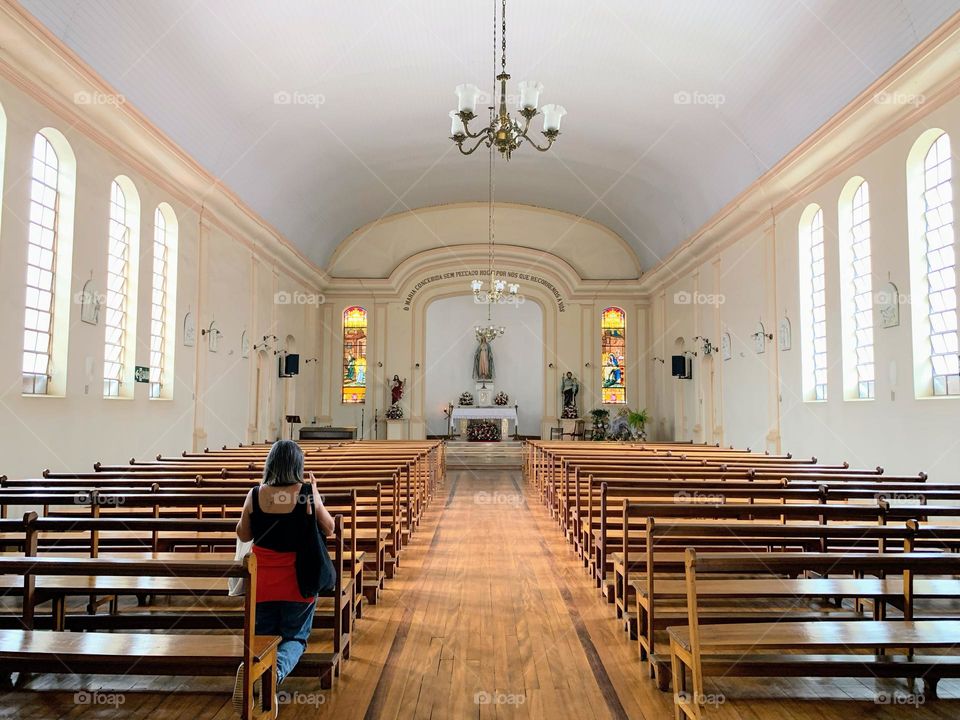 Woman praying inside a church