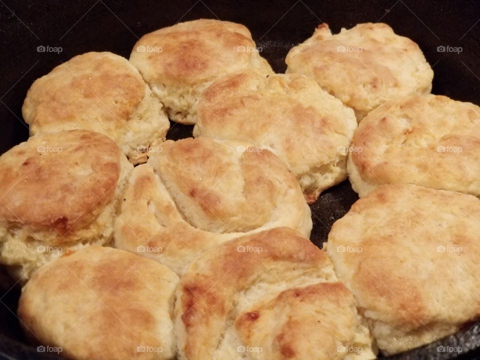 Homemade fluffy, flaky, buttermilk biscuits cooked in a cast iron skillet