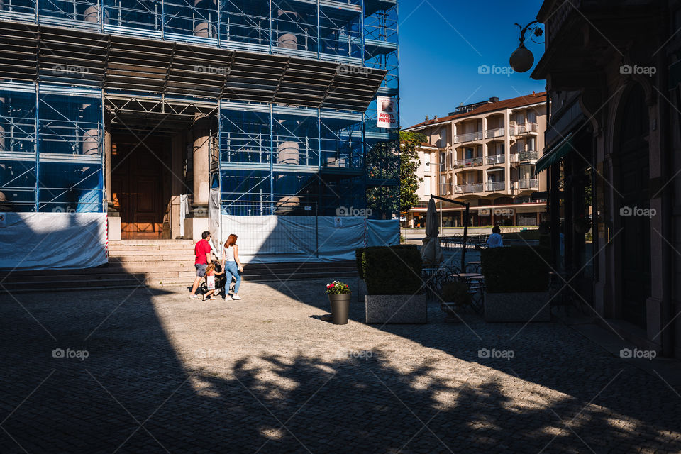 Family strolling in front of the church of Verbania