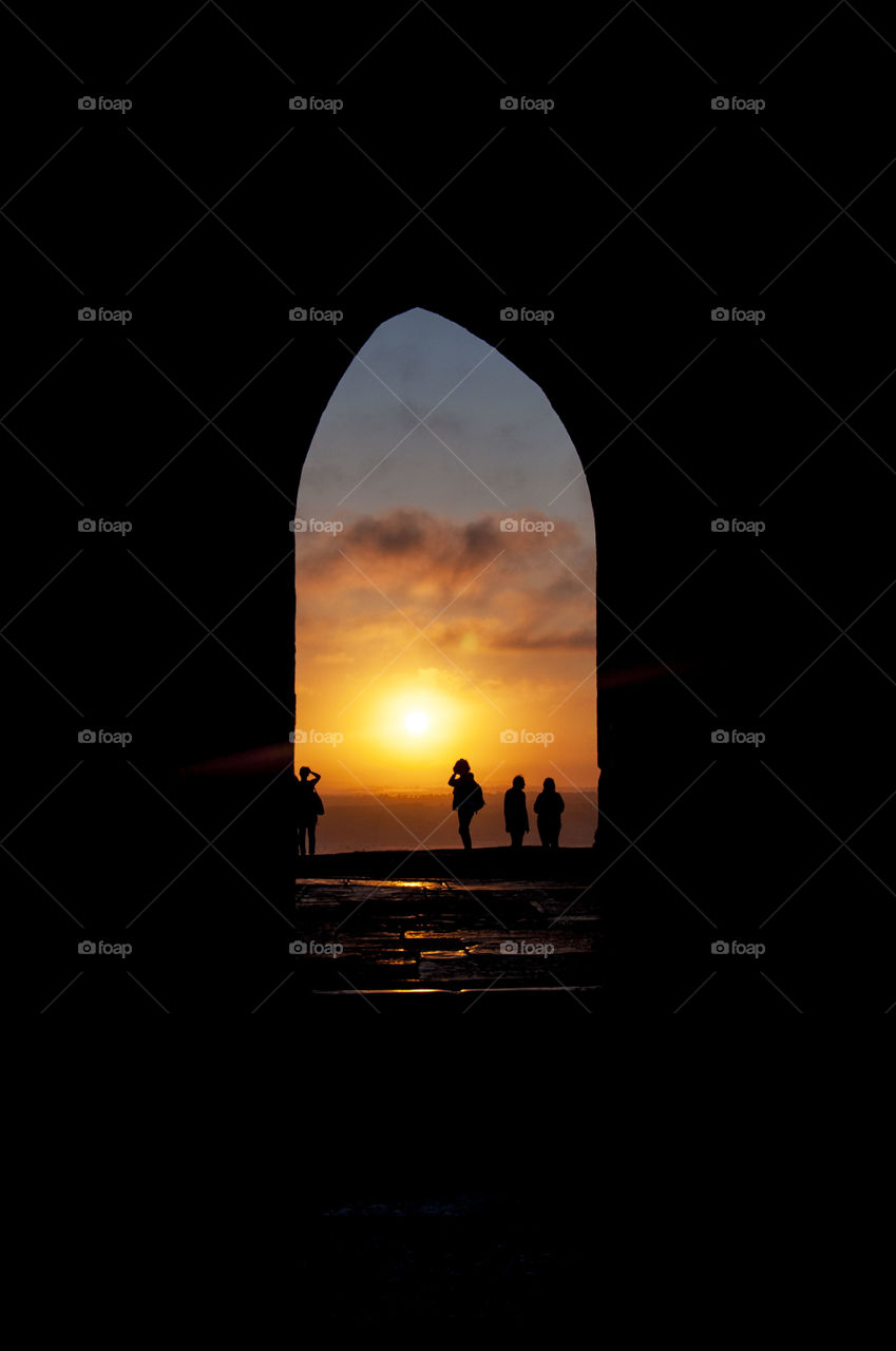 sunrise through the arch of Glastonbury Thor