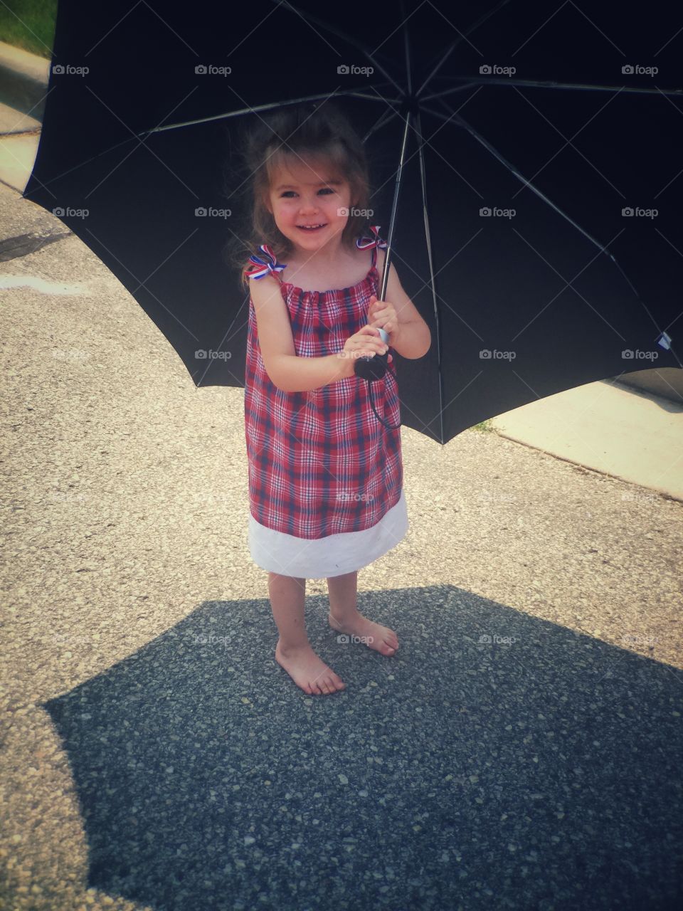 Girl holding black big umbrella