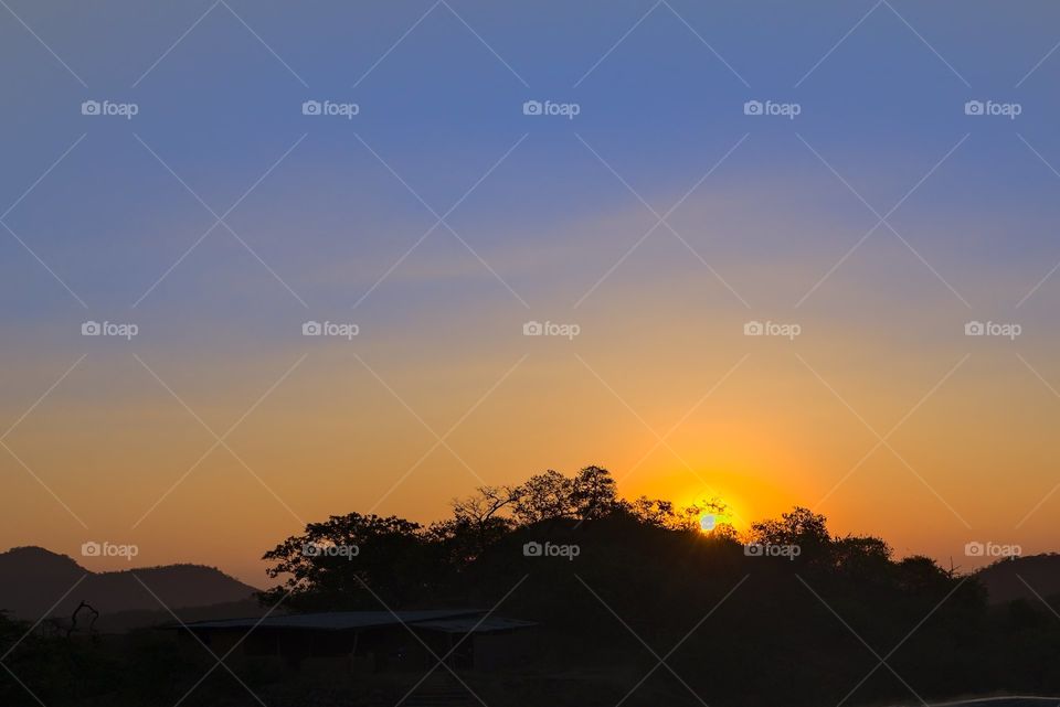 Horizon with sun and yellow and blue sky