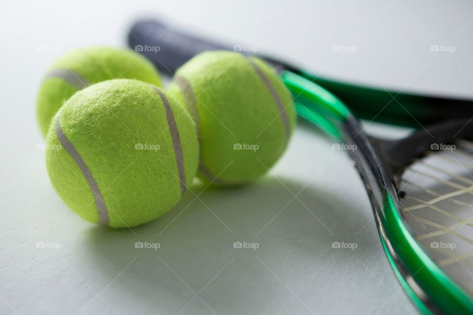 Tennis balls shadow and racket