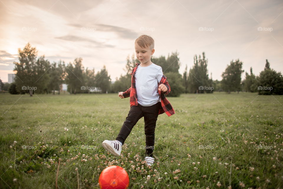 Little boy playing in soccer in a park 