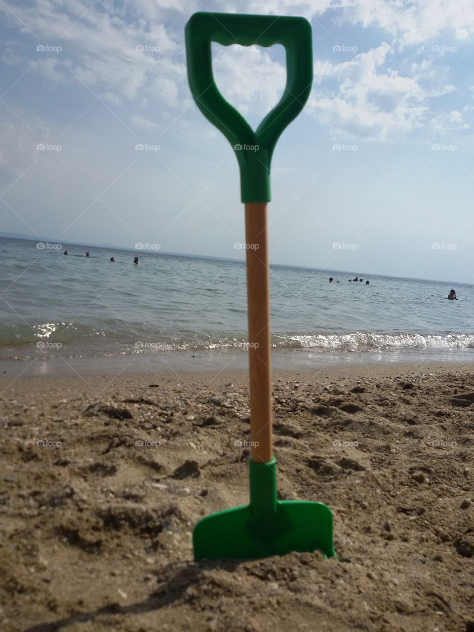 Kids rake on the beach