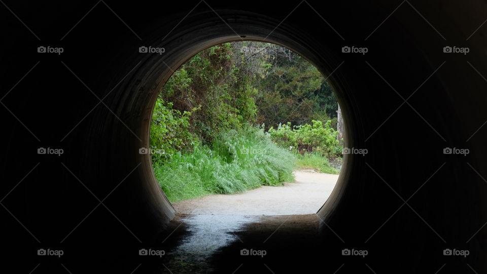 Seeing light at the end of the tunnel while on a hike.