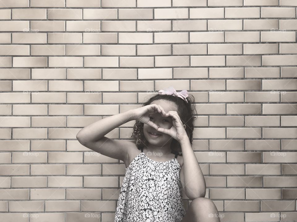 child making heart by hand