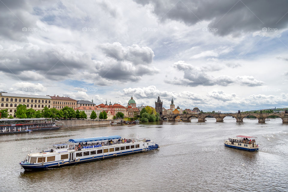 Cruise boats passing by Vltava river in Prague