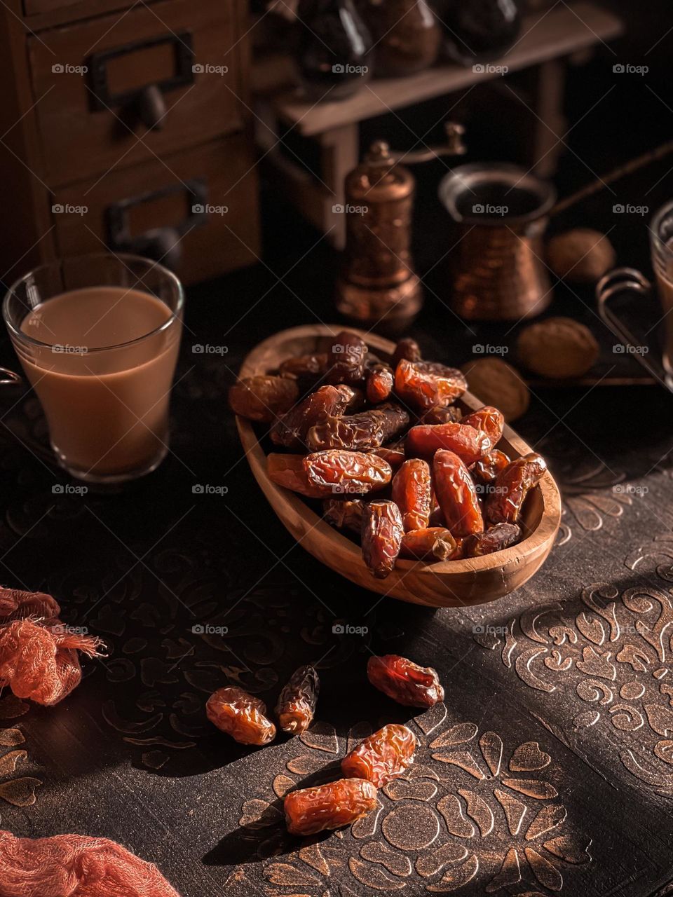 Close up view of dates with a cup of milk tea