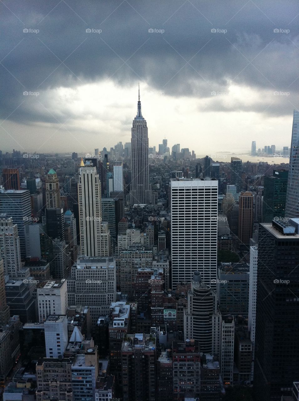 NYC Skyline View on the Empire State Building and Steel Multistoried Skyscrapers from the Top of the Rock Observation Deck Before Storm - Overcast Gray Cloudy Moody Sky